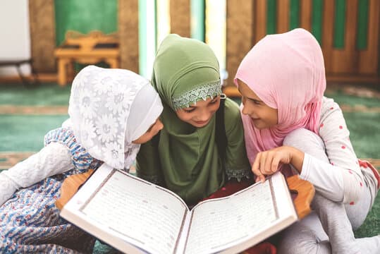 Young students reading together from a large book in class